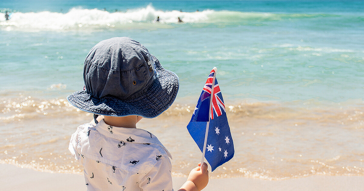 Child with Australian flag at the beach