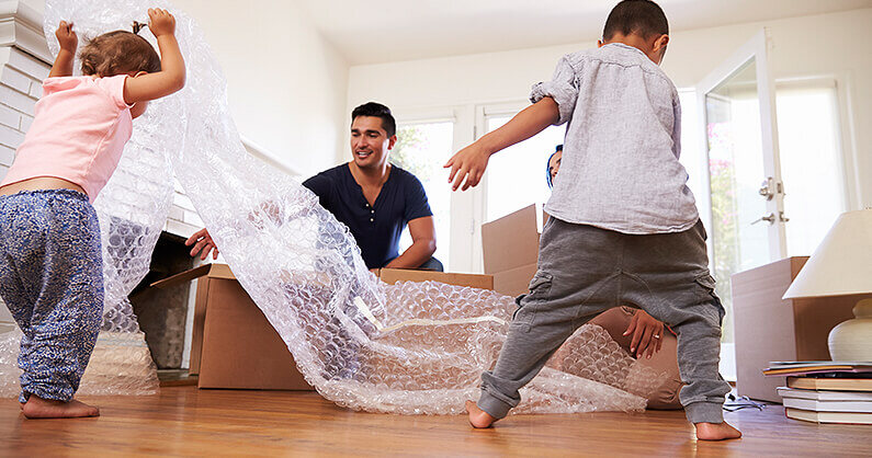 Family with packing boxes and bubble wrap