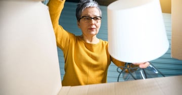 woman putting a lamp in a box